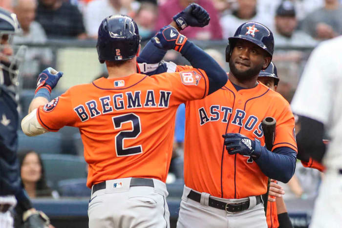 Houston Astros left fielder Yordan Álvarez celebrates with teammate Alex Bregman.